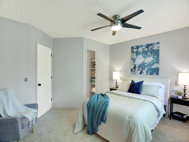453 Arden Cir, Highlands Ranch, CO 80126 - bedroom featuring light carpet, a textured ceiling, a closet, ceiling fan, and a walk in closet