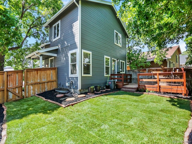 453 Arden Cir, Highlands Ranch, CO 80126 - rear view of house featuring a fenced backyard and a wooden deck