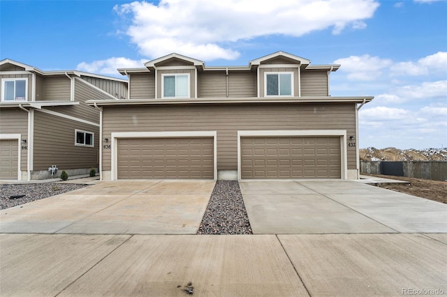 traditional-style house featuring a garage and driveway