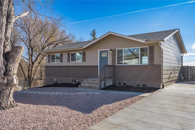 ranch-style house with brick siding, fence, and driveway