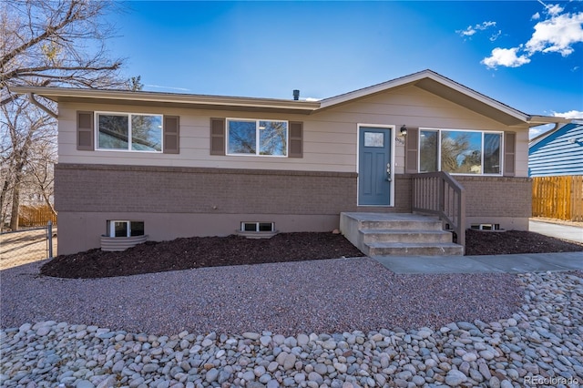 single story home with brick siding and fence