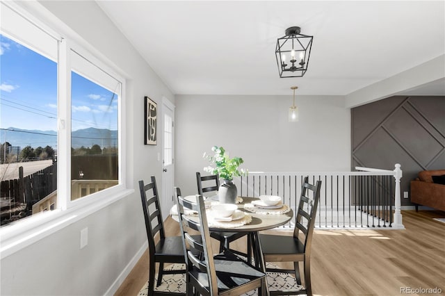 dining space featuring a notable chandelier and light wood-type flooring