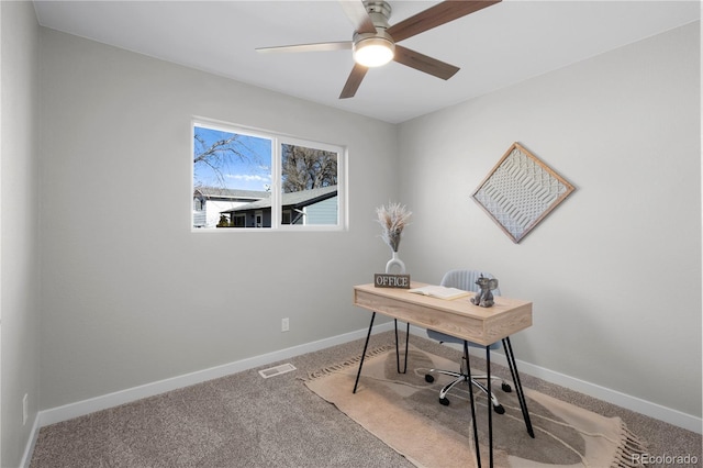 office space featuring ceiling fan and carpet