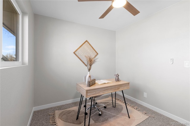 home office with ceiling fan and carpet