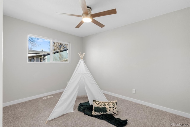 recreation room featuring carpet and ceiling fan