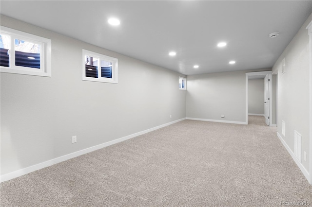 basement featuring light colored carpet