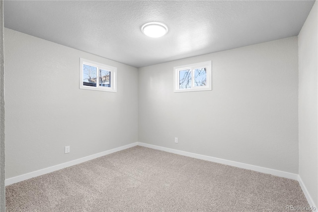 basement with a textured ceiling and carpet floors