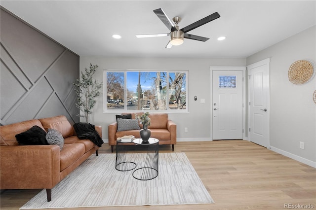 living room with light wood finished floors, baseboards, a ceiling fan, and recessed lighting