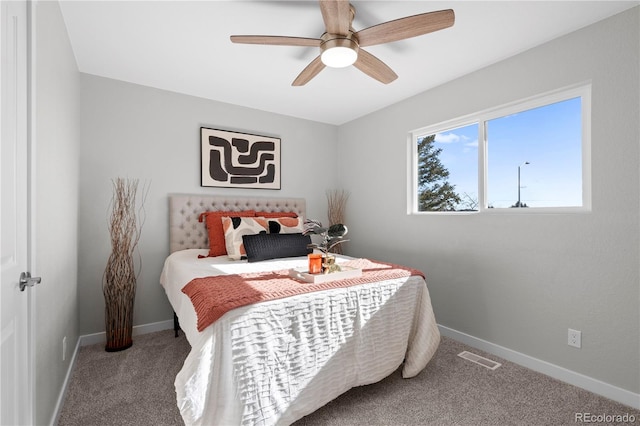 bedroom with a ceiling fan, carpet flooring, visible vents, and baseboards