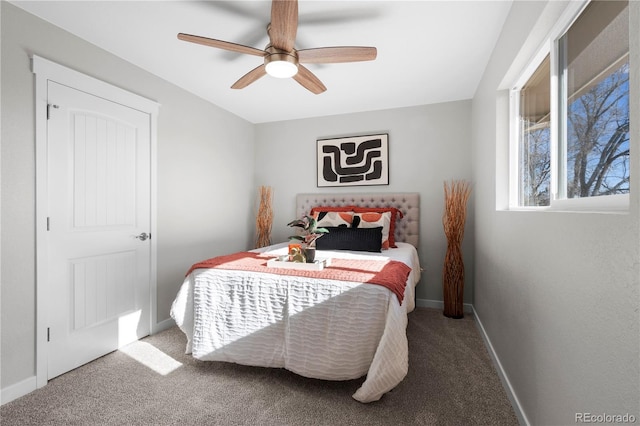 carpeted bedroom featuring a ceiling fan and baseboards