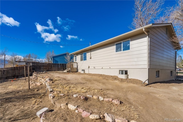 back of property with fence