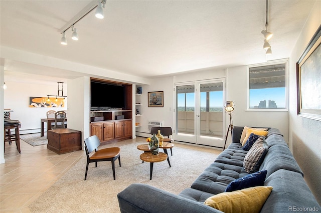 living area with track lighting, french doors, light tile patterned flooring, and baseboard heating