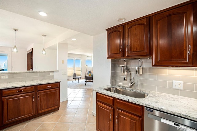 kitchen featuring a sink, backsplash, stainless steel dishwasher, and light stone countertops