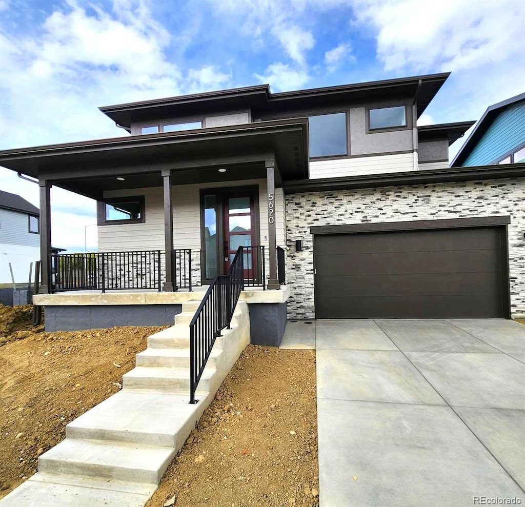 view of front of home featuring a porch and a garage