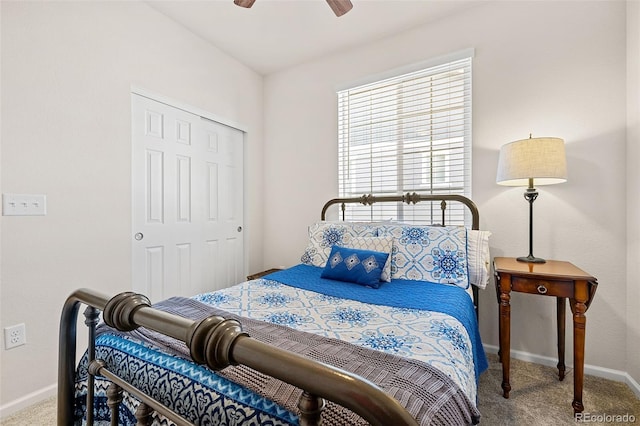 carpeted bedroom with ceiling fan and a closet