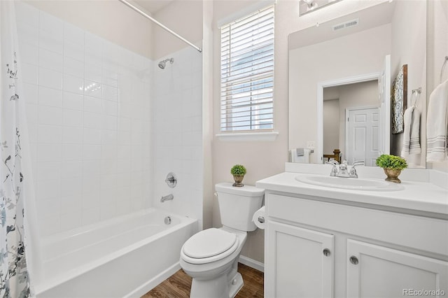 full bathroom with shower / bathtub combination with curtain, wood-type flooring, toilet, and vanity