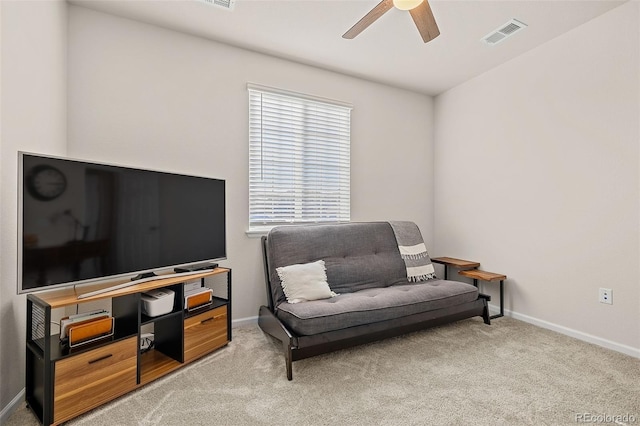 sitting room featuring light colored carpet and ceiling fan