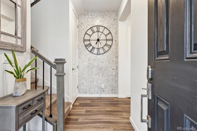 entryway featuring wood finished floors, stairway, baseboards, and wallpapered walls