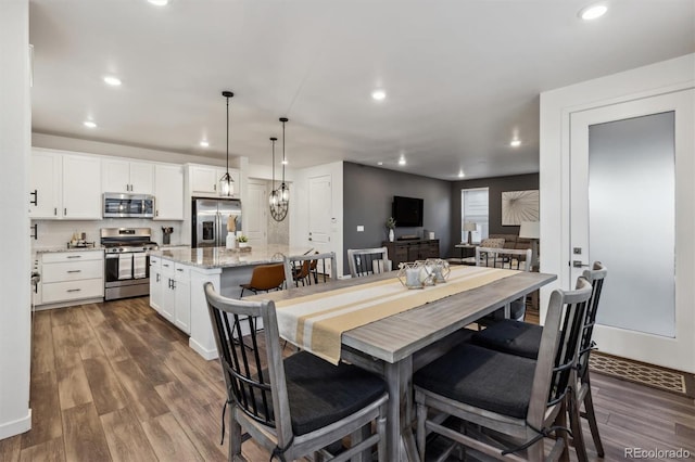 dining space with recessed lighting and dark wood finished floors