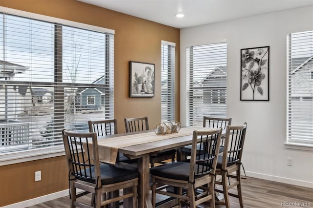 dining area featuring recessed lighting, baseboards, and wood finished floors