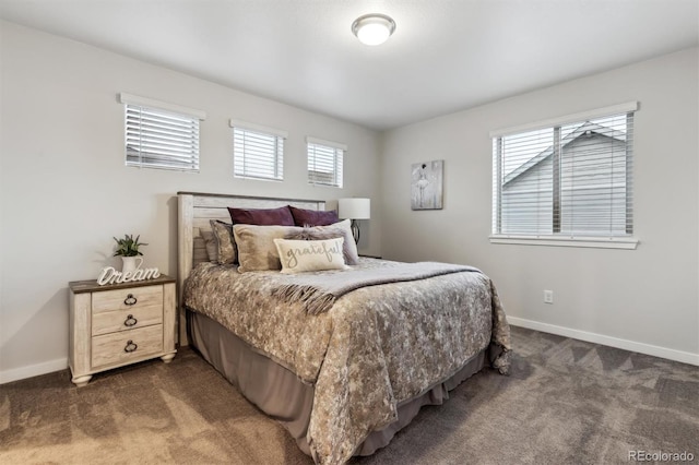 bedroom with baseboards and dark colored carpet