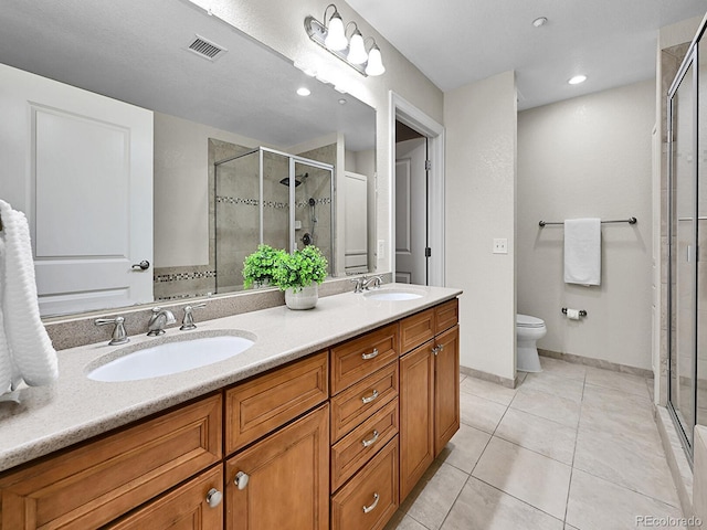 bathroom with a sink, visible vents, a stall shower, and tile patterned flooring