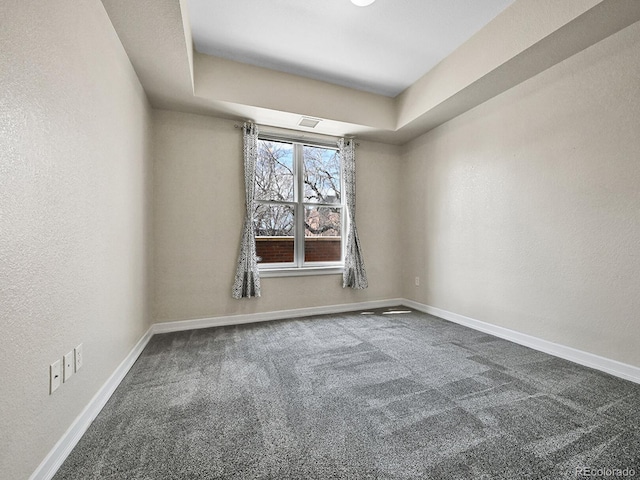 unfurnished room featuring visible vents, baseboards, and carpet floors