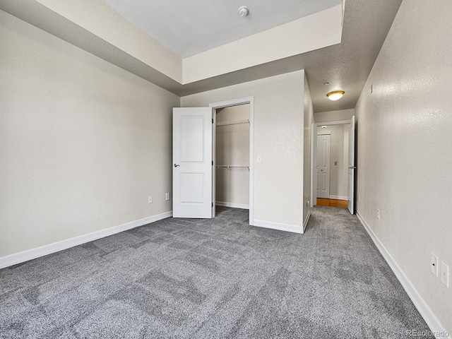 unfurnished bedroom with baseboards and carpet