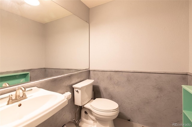 9400 E Iliff Ave Unit 411, Denver, CO 80231 - half bath with toilet, a wainscoted wall, and a sink