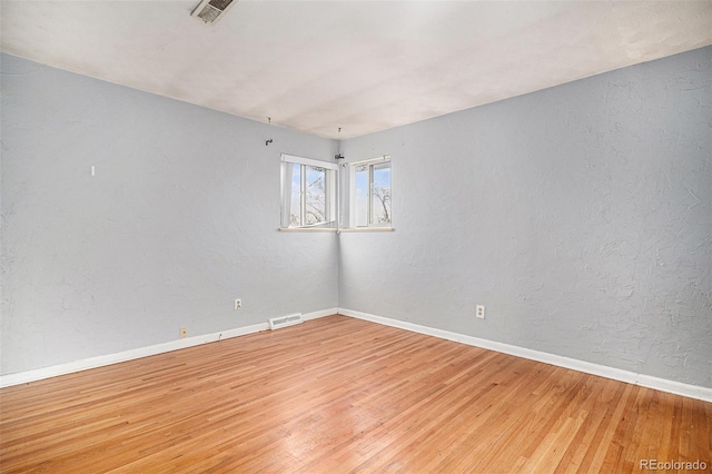 unfurnished room with hardwood / wood-style floors