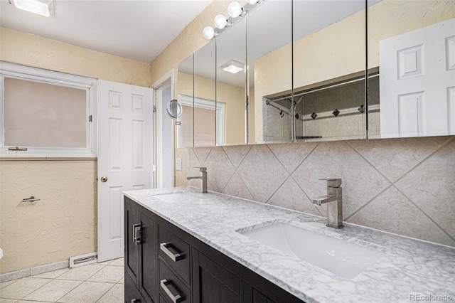 bathroom with vanity, tile patterned flooring, and decorative backsplash