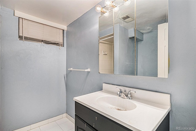 bathroom with tile patterned flooring and vanity