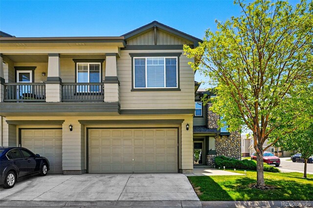 13020 Grant Cir W Unit A, Thornton, CO 80241 - view of front facade featuring an attached garage, driveway, a front lawn, and a balcony