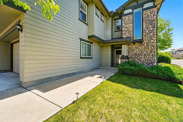 13020 Grant Cir W Unit A, Thornton, CO 80241 - doorway to property with a lawn and stone siding