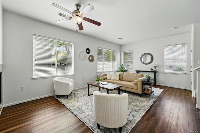 13020 Grant Cir W Unit A, Thornton, CO 80241 - living area featuring healthy amount of natural light, a ceiling fan, wood finished floors, and baseboards