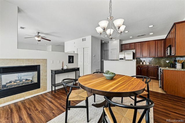 13020 Grant Cir W Unit A, Thornton, CO 80241 - dining space with ceiling fan, wood finished floors, a chandelier, recessed lighting, and a fireplace