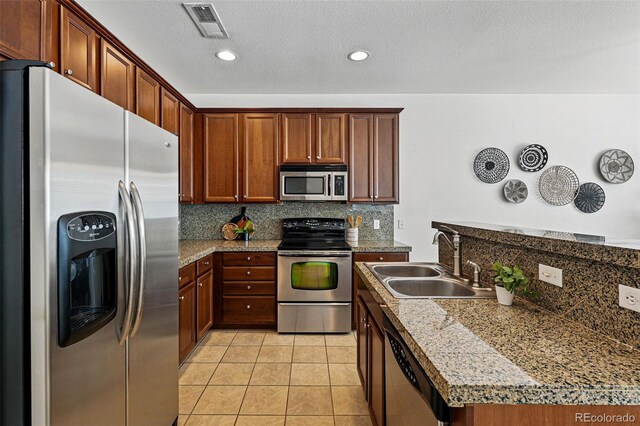 13020 Grant Cir W Unit A, Thornton, CO 80241 - kitchen featuring appliances with stainless steel finishes, a sink, tasteful backsplash, light tile patterned floors, and recessed lighting