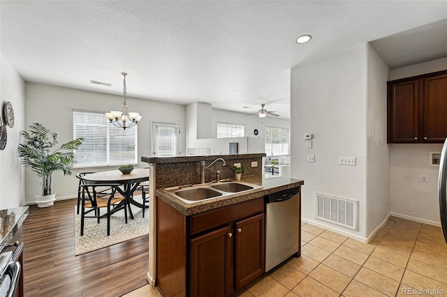 13020 Grant Cir W Unit A, Thornton, CO 80241 - kitchen featuring a sink, stainless steel dishwasher, dark countertops, a chandelier, and ceiling fan