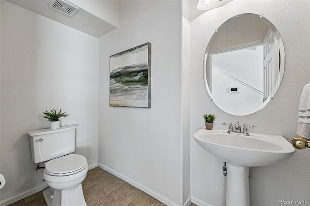 13020 Grant Cir W Unit A, Thornton, CO 80241 - half bathroom with toilet, tile patterned floors, and baseboards