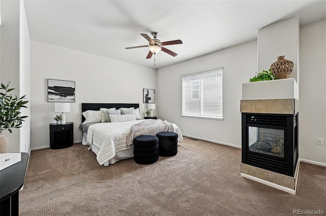 13020 Grant Cir W Unit A, Thornton, CO 80241 - bedroom featuring carpet floors, a tile fireplace, and baseboards