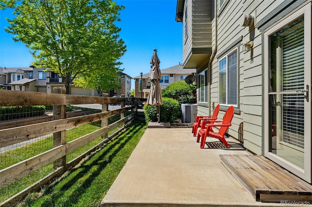 13020 Grant Cir W Unit A, Thornton, CO 80241 - view of patio with a residential view, central AC unit, and fence