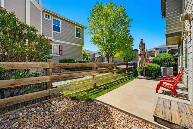 13020 Grant Cir W Unit A, Thornton, CO 80241 - view of yard featuring fence, a residential view, a patio, and cooling unit
