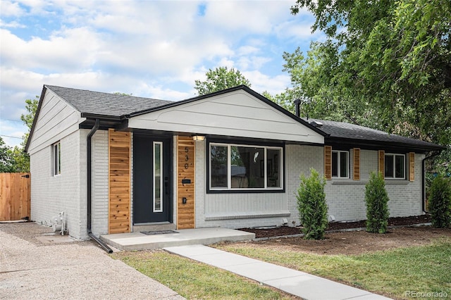 530 Everett St, Lakewood, CO 80226 - view of front of property featuring brick siding and a porch