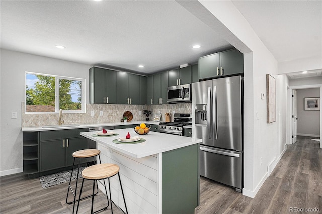 530 Everett St, Lakewood, CO 80226 - kitchen featuring appliances with stainless steel finishes, wood finished floors, backsplash, and recessed lighting