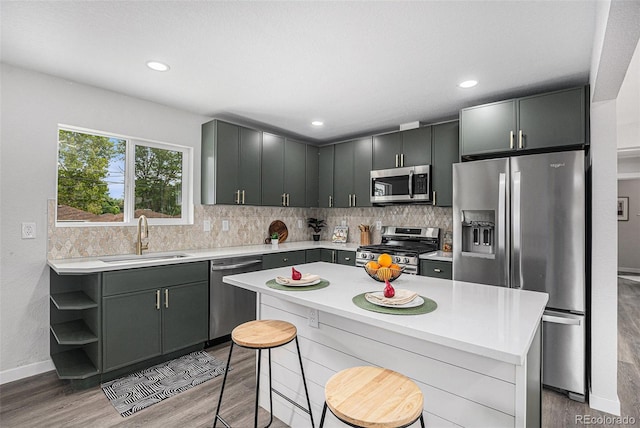 530 Everett St, Lakewood, CO 80226 - kitchen featuring stainless steel appliances, light wood-style flooring, light countertops, tasteful backsplash, and recessed lighting