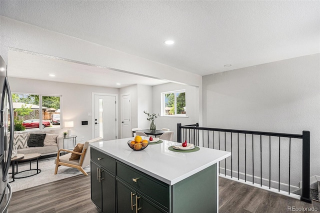 530 Everett St, Lakewood, CO 80226 - kitchen with dark wood-style floors, open floor plan, a kitchen island, light countertops, and recessed lighting