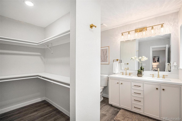530 Everett St, Lakewood, CO 80226 - full bathroom featuring double vanity, wood finished floors, a spacious closet, and recessed lighting