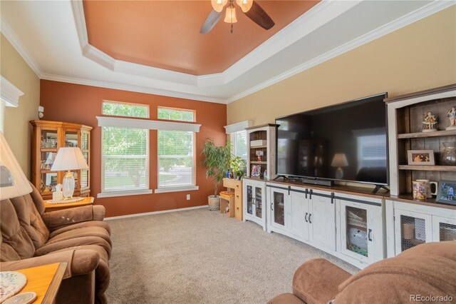 7885 Buckhorn Grn Unit 131, Frederick, CO 80530 - living area with a ceiling fan, a tray ceiling, crown molding, and carpet