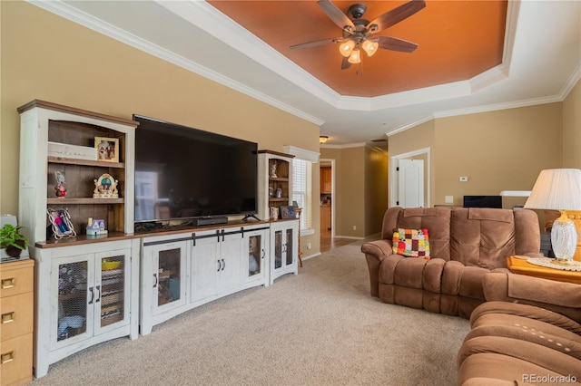 7885 Buckhorn Grn Unit 131, Frederick, CO 80530 - carpeted living area with a tray ceiling, a ceiling fan, and ornamental molding