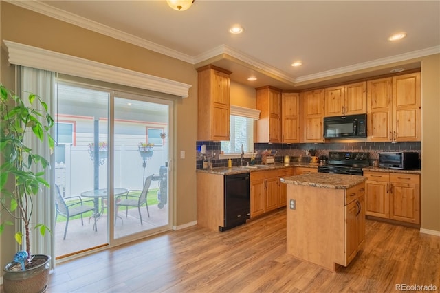 7885 Buckhorn Grn Unit 131, Frederick, CO 80530 - kitchen with black appliances, light wood-style flooring, ornamental molding, decorative backsplash, and a center island